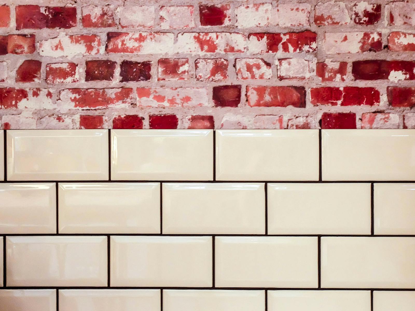 Aesthetic contrast of vintage brick with modern tile surface.